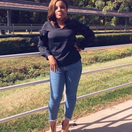 Kama Suddith Cherry in front of a fence